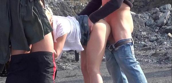  A very cute blonde young lady is fucked in public threesome at a construction site